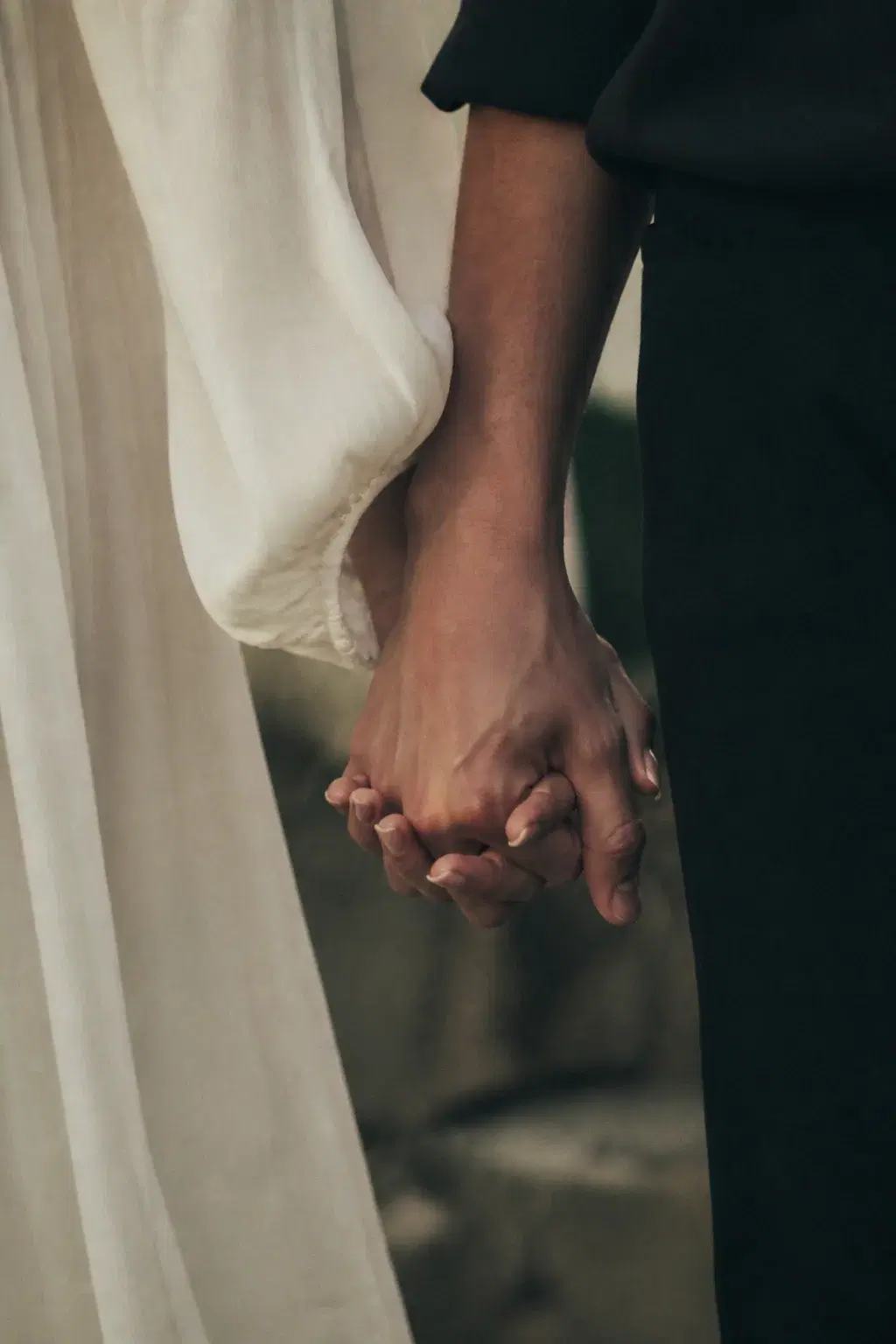 Close-up of two adult hands held together in warm cinematic light