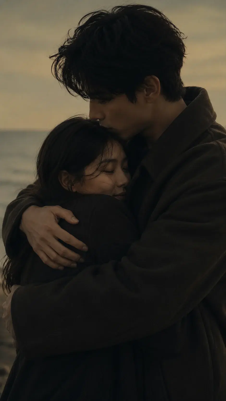 Cinematic portrait of an adult couple hugging on a beach at dusk